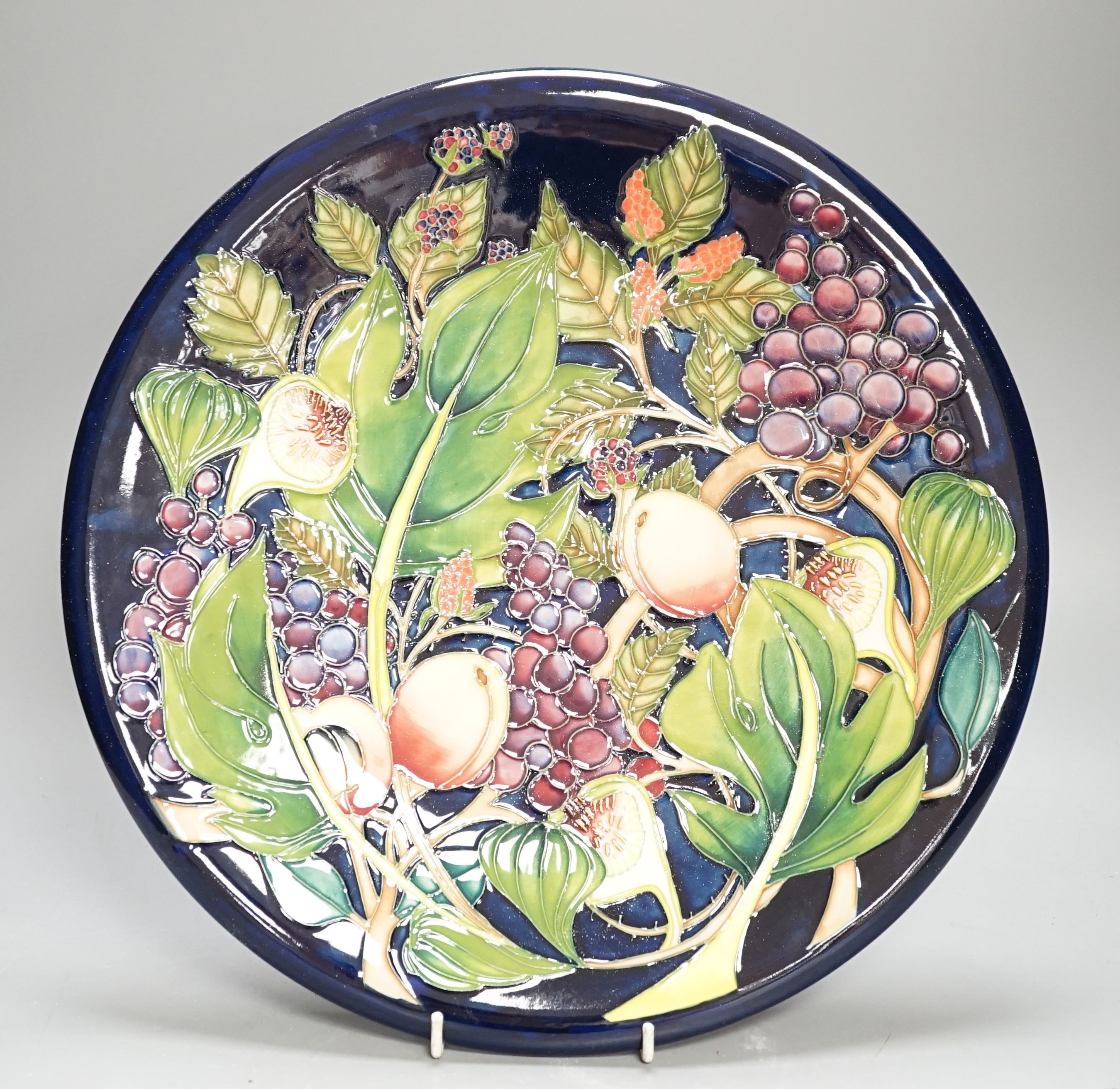 A Moorcroft Queen’s Choice pattern wall charger, dated 2003, signed by Emma Bossons, 36cm., in original box